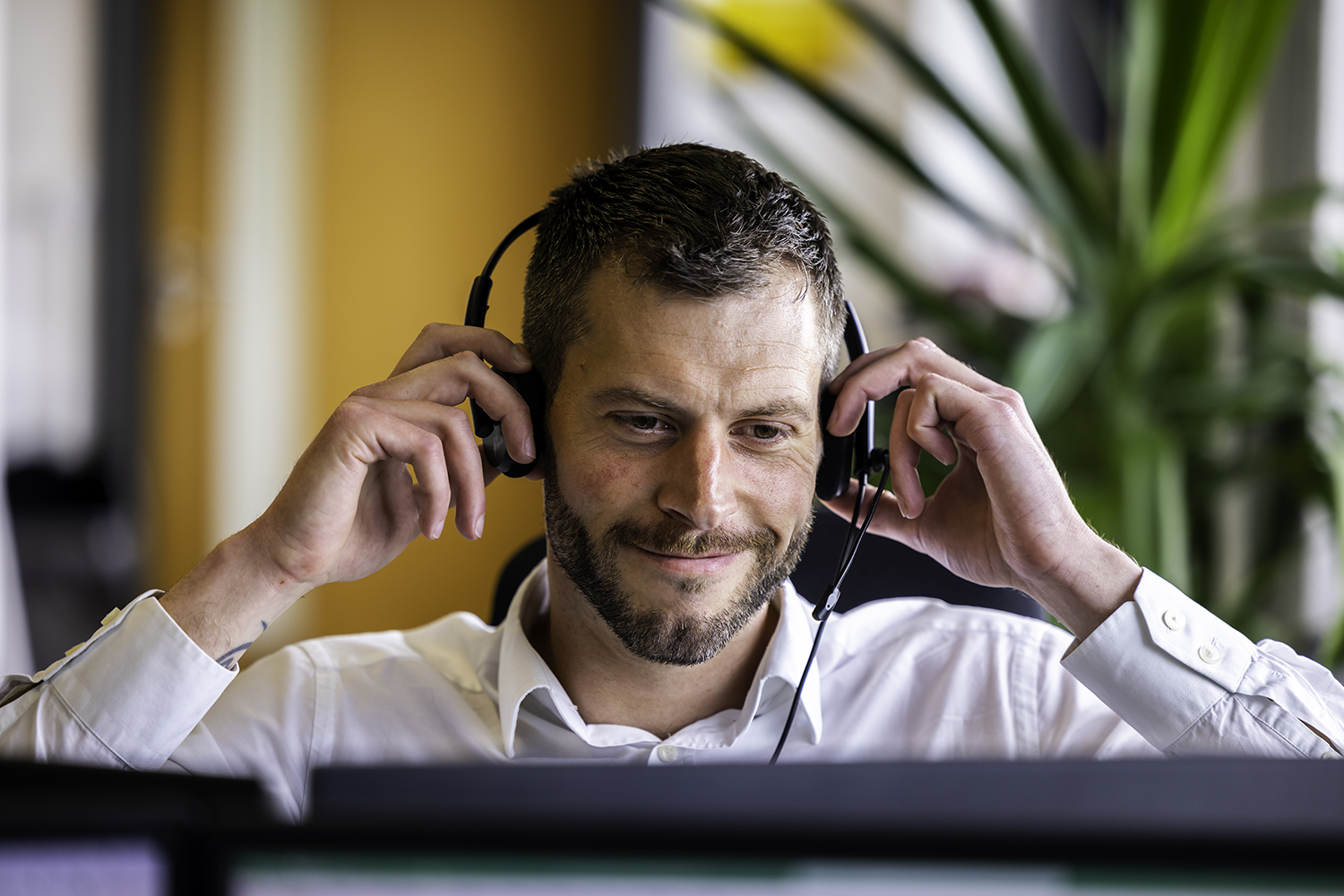James Ascott on a call with a headset